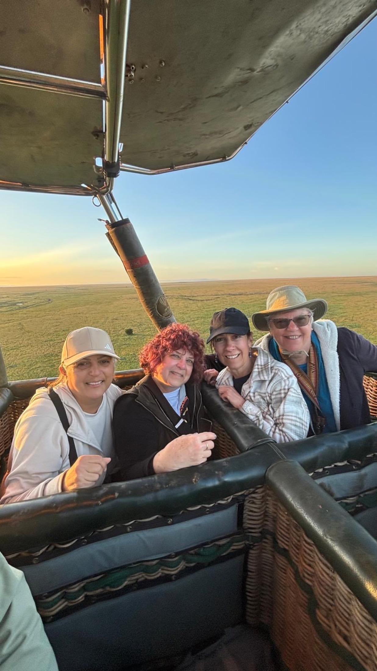 Soul-O women travelers riding in a hot air balloon basket at sunrise