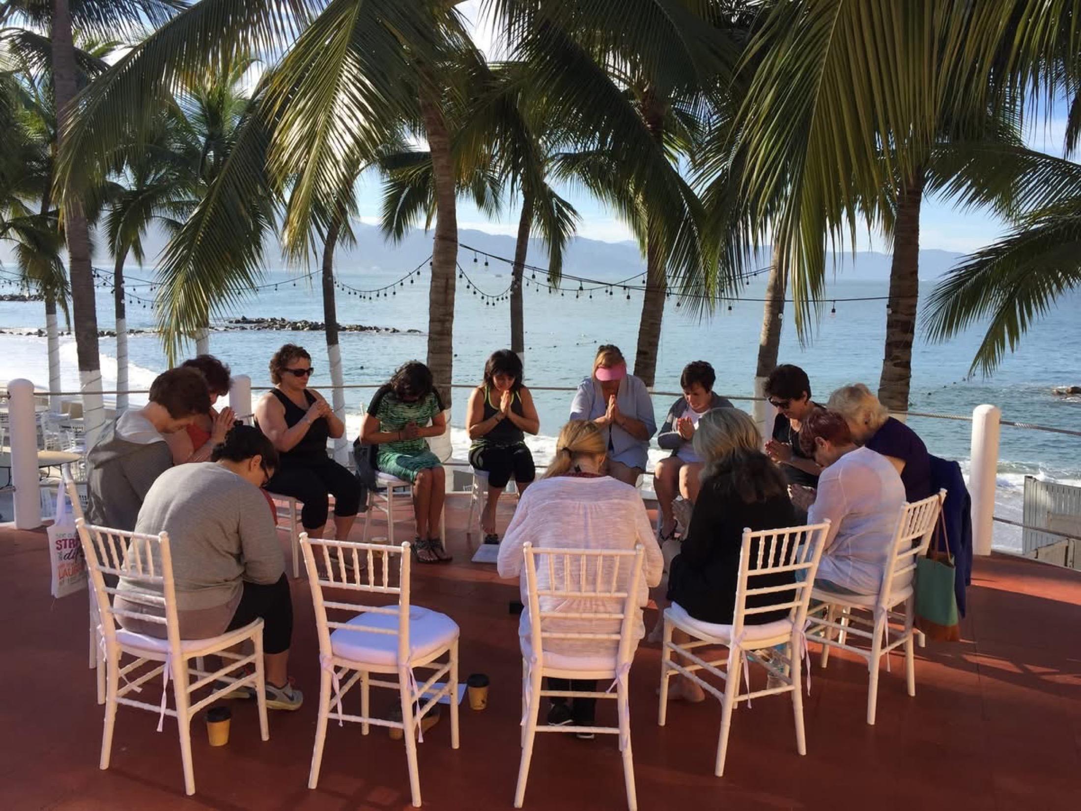 Women gathered in a coastal retreat circle